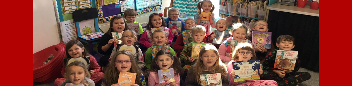 students smiling holding their new books